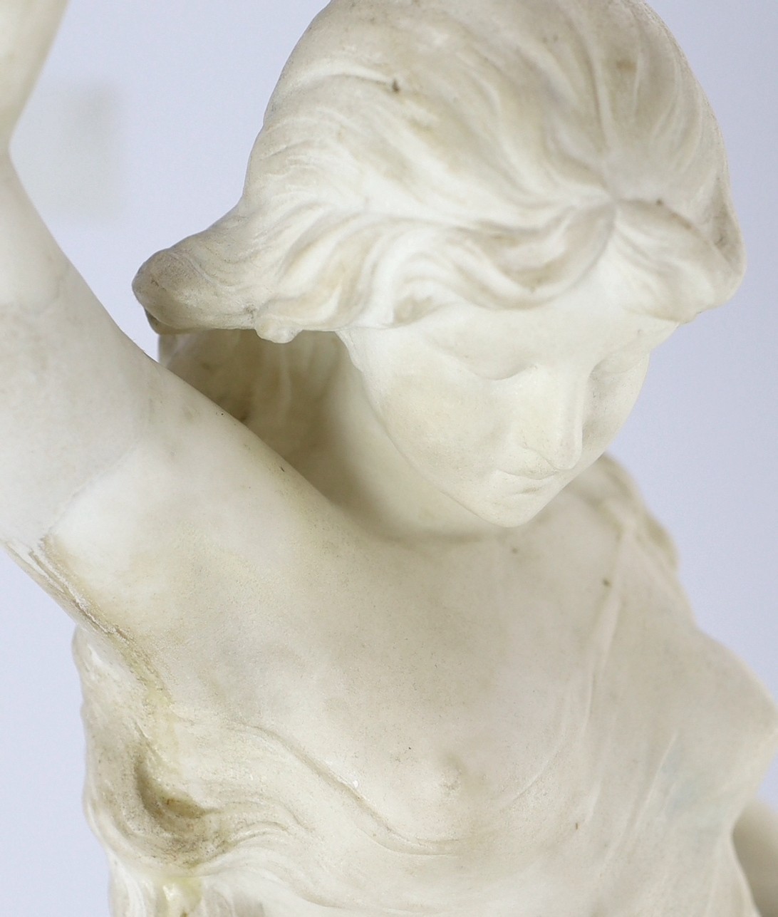 An early 20th century Continental carved white marble figure of a sea nymph riding the waves 79cm high